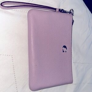 Light purple coach wristlet with 2 card slots on the inside.